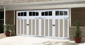 A Carriage Court garage door in sandtone and white with glass inserts.