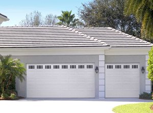 The Designer's Choice garage door with white panels and decorative glass panel inserts.
